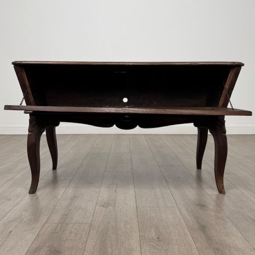 fig 1. A nineteenth-century French provincial walnut dough bin featuring hand-carved central cartouche ornamentation and shaped cabriole legs.