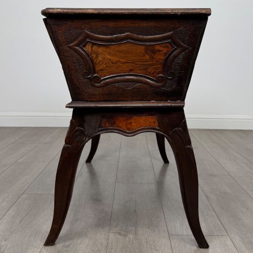 fig 2. A nineteenth-century French provincial walnut dough bin featuring hand-carved central cartouche ornamentation and shaped cabriole legs.