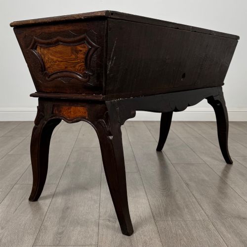 fig 3. A nineteenth-century French provincial walnut dough bin featuring hand-carved central cartouche ornamentation and shaped cabriole legs.