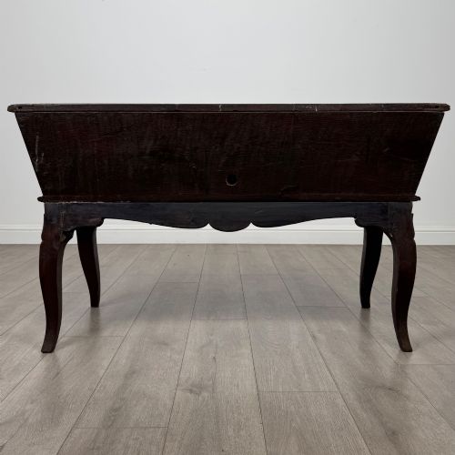 fig 4. A nineteenth-century French provincial walnut dough bin featuring hand-carved central cartouche ornamentation and shaped cabriole legs.
