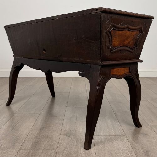 fig 5. A nineteenth-century French provincial walnut dough bin featuring hand-carved central cartouche ornamentation and shaped cabriole legs.