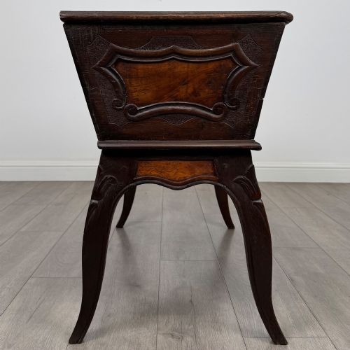 fig 6. A nineteenth-century French provincial walnut dough bin featuring hand-carved central cartouche ornamentation and shaped cabriole legs.