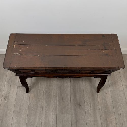 fig 8. A nineteenth-century French provincial walnut dough bin featuring hand-carved central cartouche ornamentation and shaped cabriole legs.