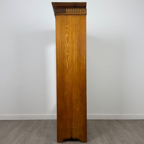 fig 3. A 19th-century ash compactum wardrobe featuring a full-length mirrored door on the left and a carved cupboard with four drawers on the right above a long base drawer.