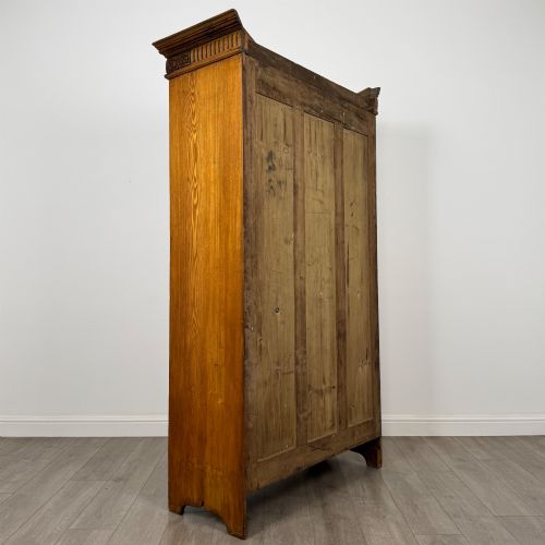 fig 4. A 19th-century ash compactum wardrobe featuring a full-length mirrored door on the left and a carved cupboard with four drawers on the right above a long base drawer.