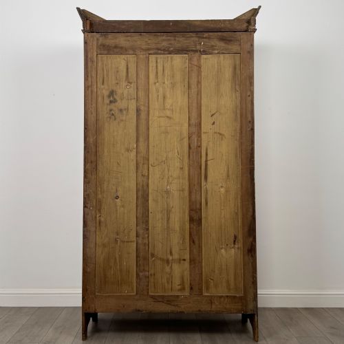 fig 5. A 19th-century ash compactum wardrobe featuring a full-length mirrored door on the left and a carved cupboard with four drawers on the right above a long base drawer.