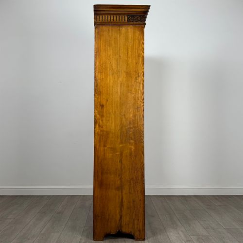 fig 7. A 19th-century ash compactum wardrobe featuring a full-length mirrored door on the left and a carved cupboard with four drawers on the right above a long base drawer.