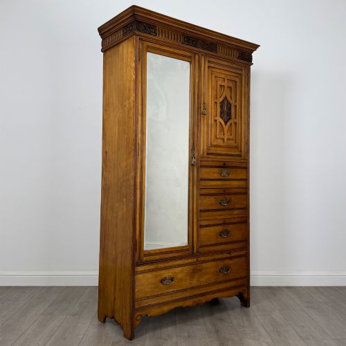 fig 8. A 19th-century ash compactum wardrobe featuring a full-length mirrored door on the left and a carved cupboard with four drawers on the right above a long base drawer.