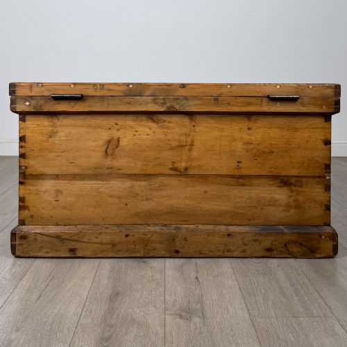 fig 4. A nineteenth-century pine storage chest featuring visible hand-cut dovetail corner joints and a moulded base.