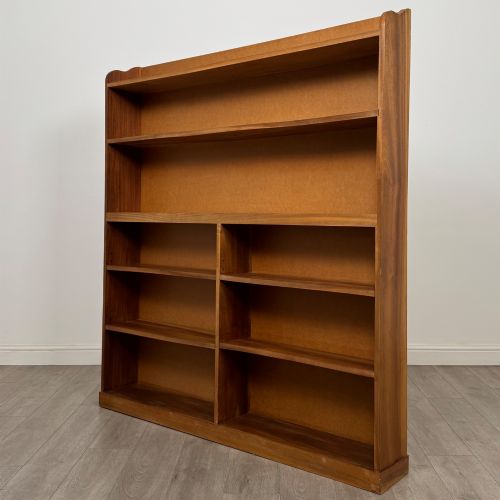fig 1. A large twentieth-century open walnut bookcase featuring multiple fixed shelves with a central divider on the lower section.
