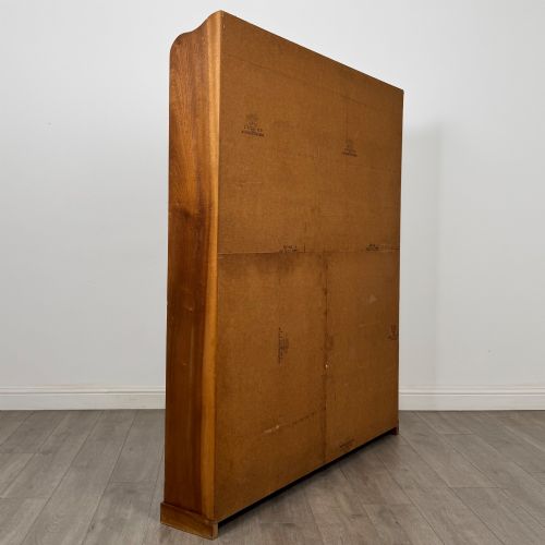 fig 3. A large twentieth-century open walnut bookcase featuring multiple fixed shelves with a central divider on the lower section.