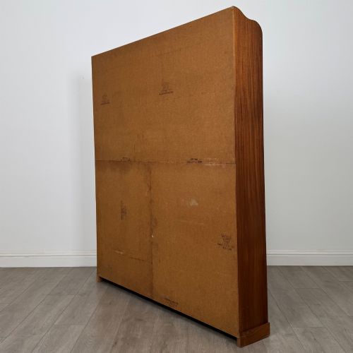 fig 5. A large twentieth-century open walnut bookcase featuring multiple fixed shelves with a central divider on the lower section.