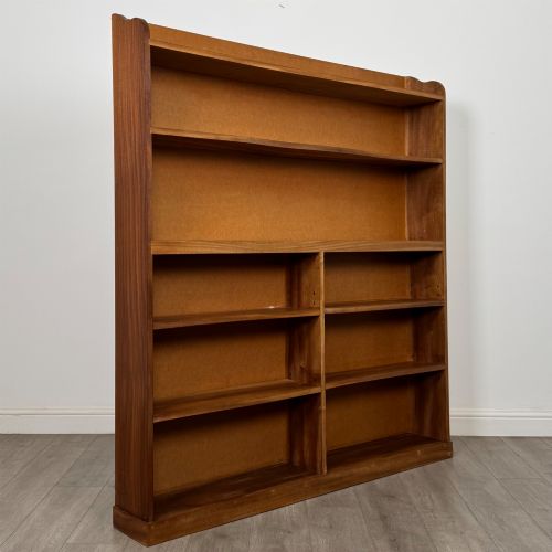 fig 7. A large twentieth-century open walnut bookcase featuring multiple fixed shelves with a central divider on the lower section.