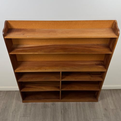fig 8. A large twentieth-century open walnut bookcase featuring multiple fixed shelves with a central divider on the lower section.