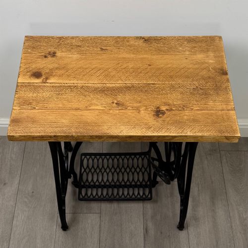 fig 8. An industrial side table featuring a black cast iron Jones treadle sewing machine base topped with a thick rectangular timber board.