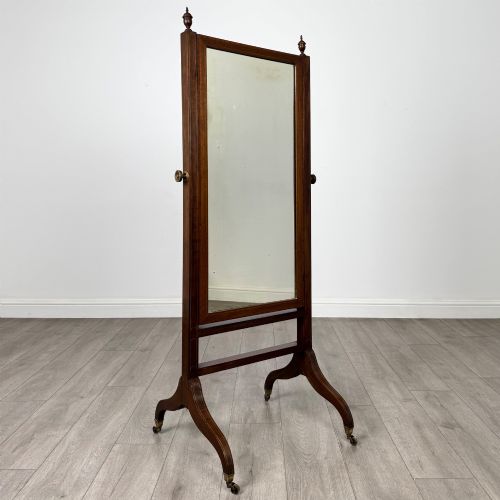 fig 8. An Edwardian mahogany full-length cheval mirror featuring a rectangular tilting glass frame supported by a wooden upright stand with finials and splayed feet on brass castors.