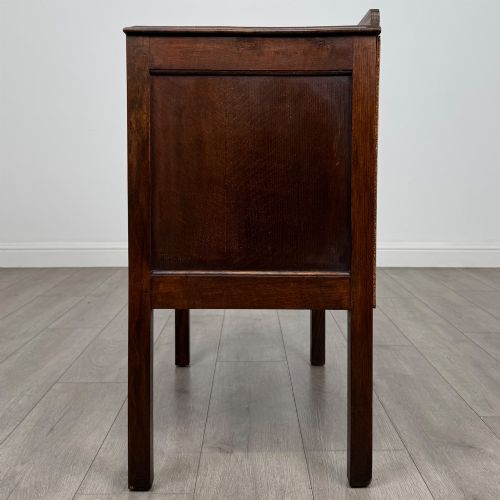 fig 2. A two-drawer golden oak chest of drawers featuring decorative metal drop handles and straight square legs.