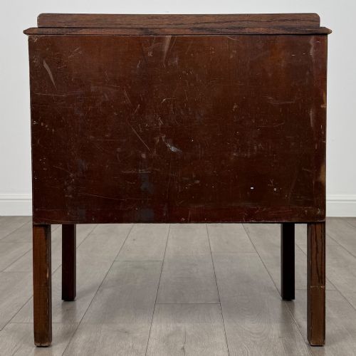 fig 4. A two-drawer golden oak chest of drawers featuring decorative metal drop handles and straight square legs.