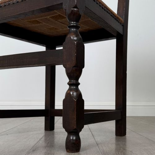 fig 7. A set of six Edwardian dark oak dining chairs with tan studded leather upholstery, comprising two carver armchairs and four side chairs featuring turned legs.