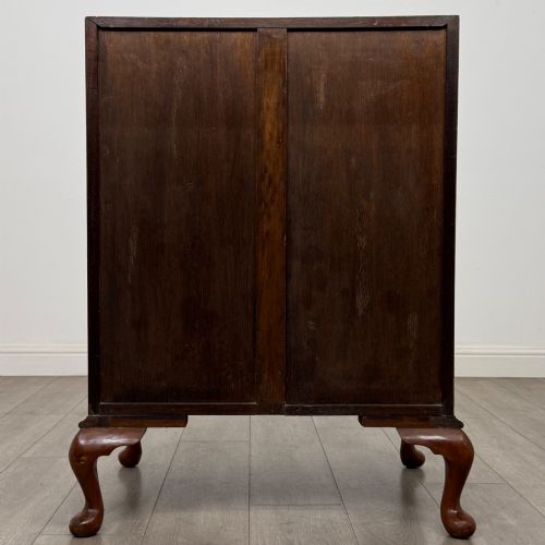 fig 5. An Edwardian burr walnut writing bureau featuring a sloping fall front, three drawers with decorative brass handles, and cabriole legs.