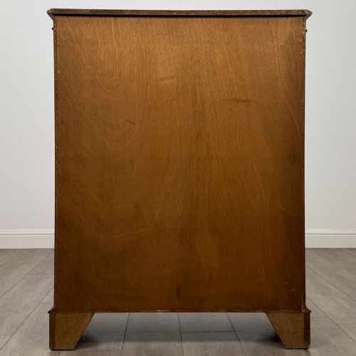 fig 6. An antique yew wood display cabinet featuring two astragal glazed doors with geometric glazing bars, housing books on internal shelves, and resting on bracket feet.