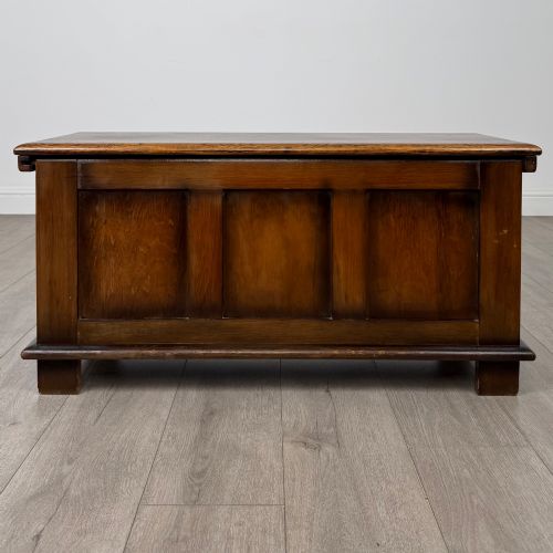 fig 4. A rectangular dark oak blanket box featuring three carved front panels with Gothic arched details and a flat top lid.