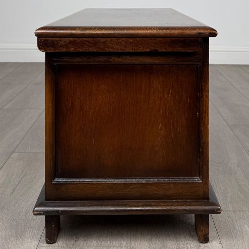 fig 6. A rectangular dark oak blanket box featuring three carved front panels with Gothic arched details and a flat top lid.