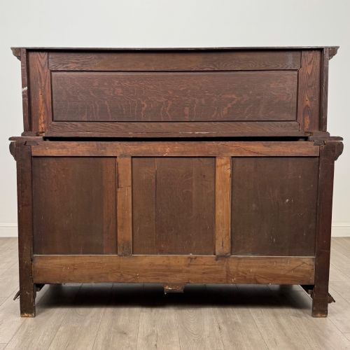 fig 5. A dark oak 19th-century sideboard featuring deep relief carvings of Green Man mythical faces, foliate motifs, lion masks, and an arched upper gallery shelf.