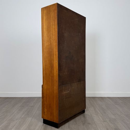 fig 5. A tall vintage golden oak display cabinet featuring glazed sliding doors on top and a two-door cupboard base.
