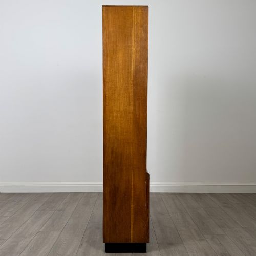 fig 8. A tall vintage golden oak display cabinet featuring glazed sliding doors on top and a two-door cupboard base.