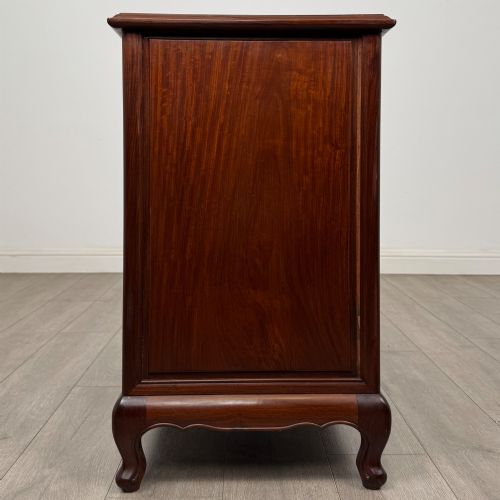 fig 2. A mahogany chest of drawers featuring a two-over-three drawer arrangement supported on cabriole feet with brass drop handles.