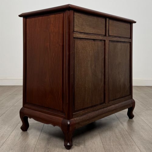 fig 3. A mahogany chest of drawers featuring a two-over-three drawer arrangement supported on cabriole feet with brass drop handles.