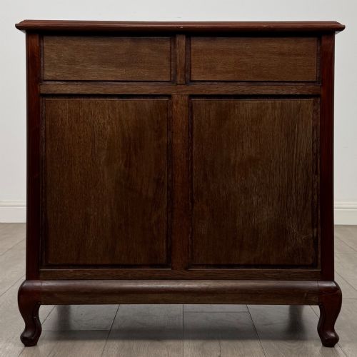 fig 4. A mahogany chest of drawers featuring a two-over-three drawer arrangement supported on cabriole feet with brass drop handles.