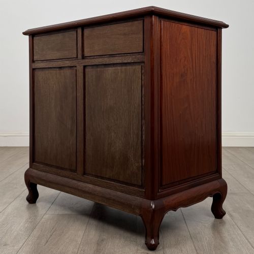 fig 5. A mahogany chest of drawers featuring a two-over-three drawer arrangement supported on cabriole feet with brass drop handles.