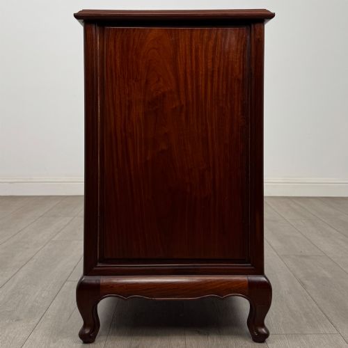 fig 6. A mahogany chest of drawers featuring a two-over-three drawer arrangement supported on cabriole feet with brass drop handles.