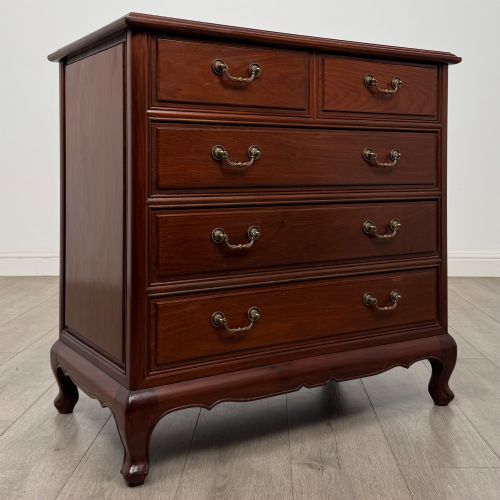 fig 7. A mahogany chest of drawers featuring a two-over-three drawer arrangement supported on cabriole feet with brass drop handles.
