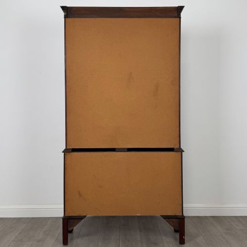 fig 5. A 20th-century Chippendale style mahogany bookcase featuring two upper glazed doors with diamond pattern astragal glazing and a two-door cupboard base raised on cabriole legs with claw and ball feet.