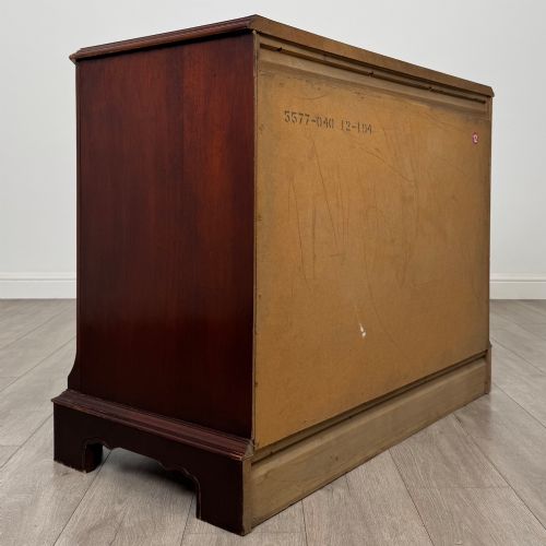 fig 3. A 20th-century American mahogany chest of drawers featuring two small top drawers, two full-width lower drawers, brass bail handles, fluted quarter-columns, and bracket feet.