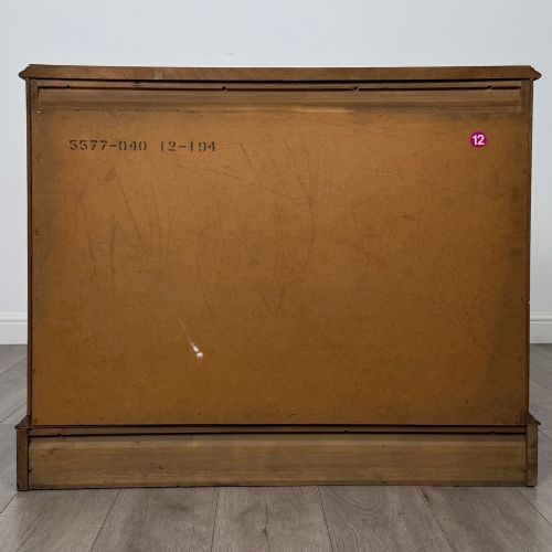 fig 4. A 20th-century American mahogany chest of drawers featuring two small top drawers, two full-width lower drawers, brass bail handles, fluted quarter-columns, and bracket feet.