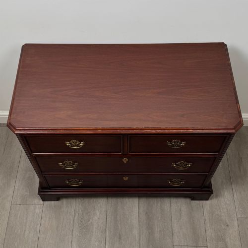 fig 8. A 20th-century American mahogany chest of drawers featuring two small top drawers, two full-width lower drawers, brass bail handles, fluted quarter-columns, and bracket feet.