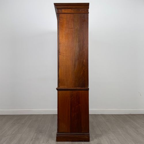 fig 3. An Edwardian walnut linen press featuring a moulded top cornice, two large upper recessed panel doors, and a lower chest of drawers with brass drop handles.
