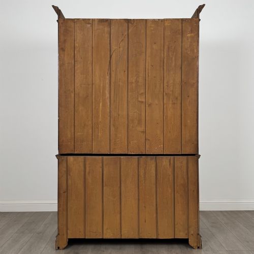 fig 5. An Edwardian walnut linen press featuring a moulded top cornice, two large upper recessed panel doors, and a lower chest of drawers with brass drop handles.