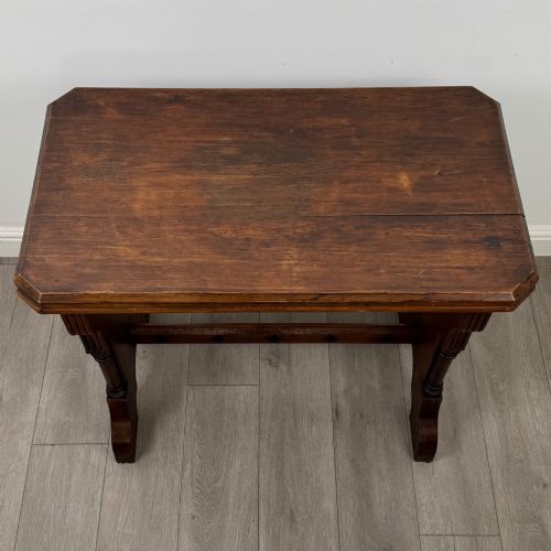 fig 3. An antique 19th-century pitch pine side table featuring a Gothic Revival trestle base with turned column details and a pegged stretcher.