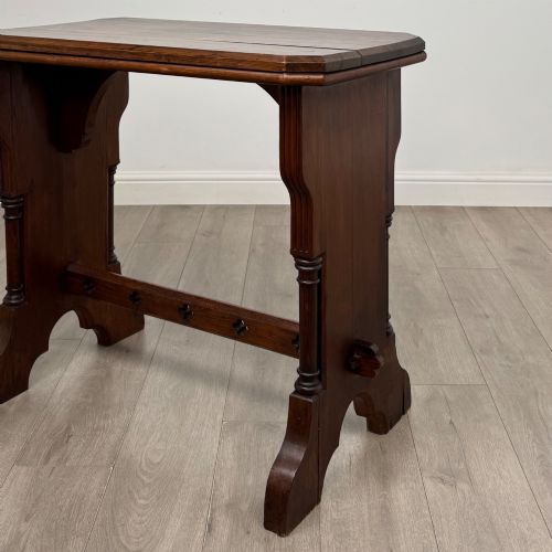 fig 4. An antique 19th-century pitch pine side table featuring a Gothic Revival trestle base with turned column details and a pegged stretcher.
