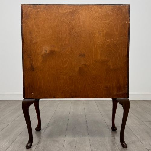 fig 5. An antique Edwardian burr walnut slant-front bureau featuring two drawers with metal handles, supported by carved cabriole legs.