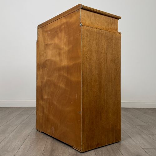 fig 5. A twentieth-century oak chest featuring four large horizontal drawers below two smaller upper drawers with turned wooden handles and a central carved fluted detail.