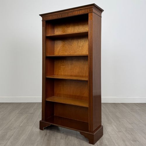 fig 2. A tall early 20th-century mahogany open bookcase featuring fluted side pilasters, a crossbanded cornice, five shelves, and bracket feet.