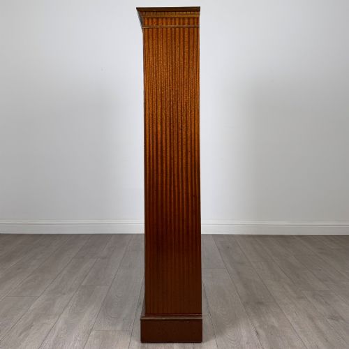 fig 3. A tall early 20th-century mahogany open bookcase featuring fluted side pilasters, a crossbanded cornice, five shelves, and bracket feet.