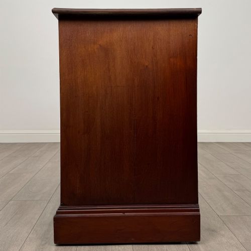 fig 2. An antique mahogany chest of drawers featuring two short top drawers over two long lower drawers with decorative metal handles on a plinth base.