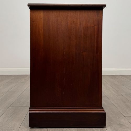 fig 6. An antique mahogany chest of drawers featuring two short top drawers over two long lower drawers with decorative metal handles on a plinth base.
